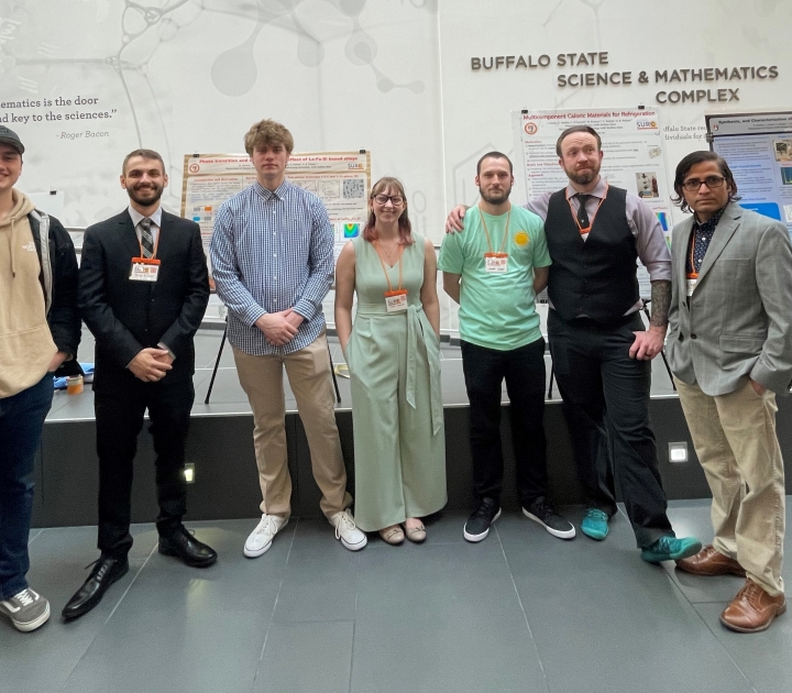 Dr. Pathak and six students standing in front of a research poster presentation at the SUNY Undergraduate Research Conference in April