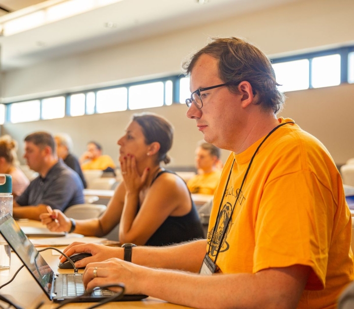 Row of participants sitting at laptops
