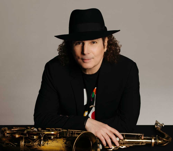 Boney James posing with his saxophone