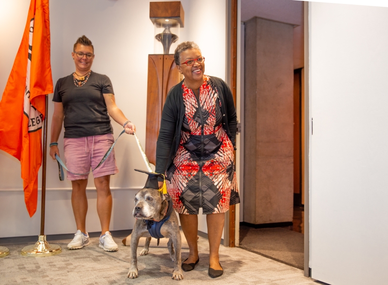 President Conway-Turner petting Lloyd the dog