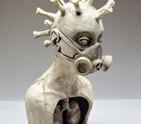 Clay scupture of head in gas mask