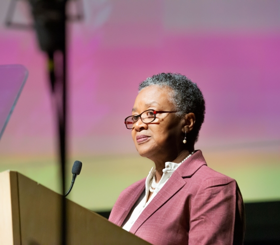 Buffalo State President Kate Conway Turner standing at lectern and speaking in the Burchfield Penney Art Center