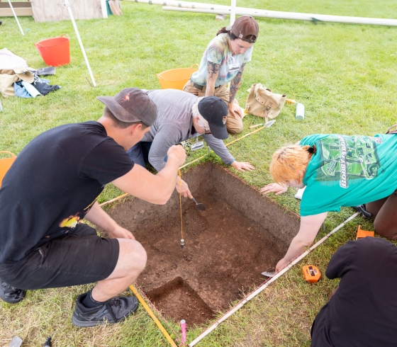 Students excavating an area of  land