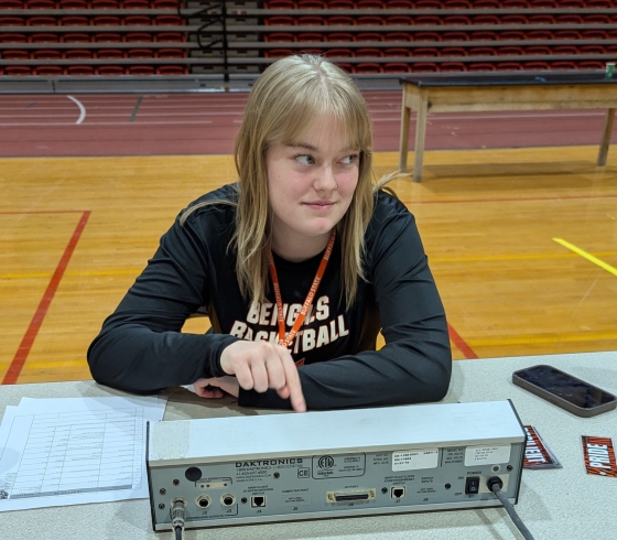 Brooke Woodard sits at a table using a digital platform