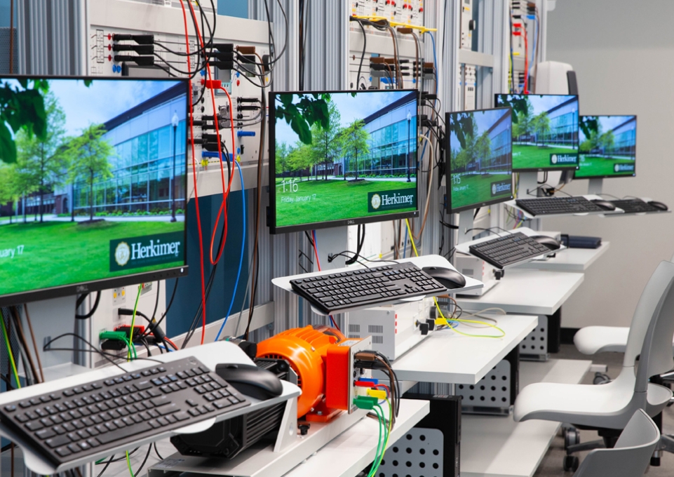 Bank of computer screens connected to circuit boards