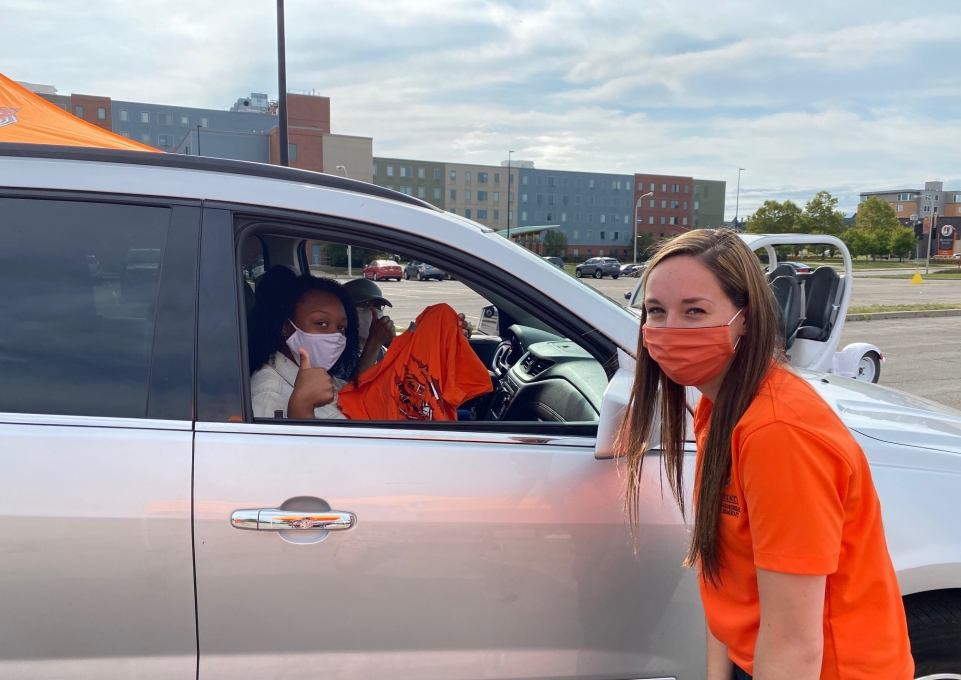 Student in car gives thumbs-up sign