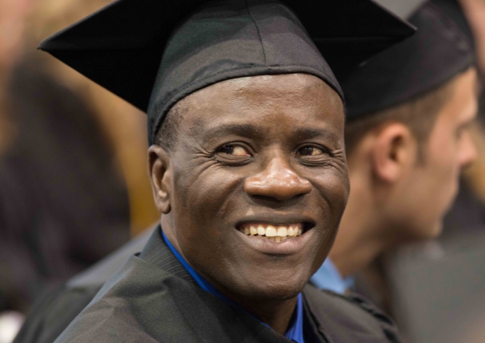 Smiling graduate in cap and gown