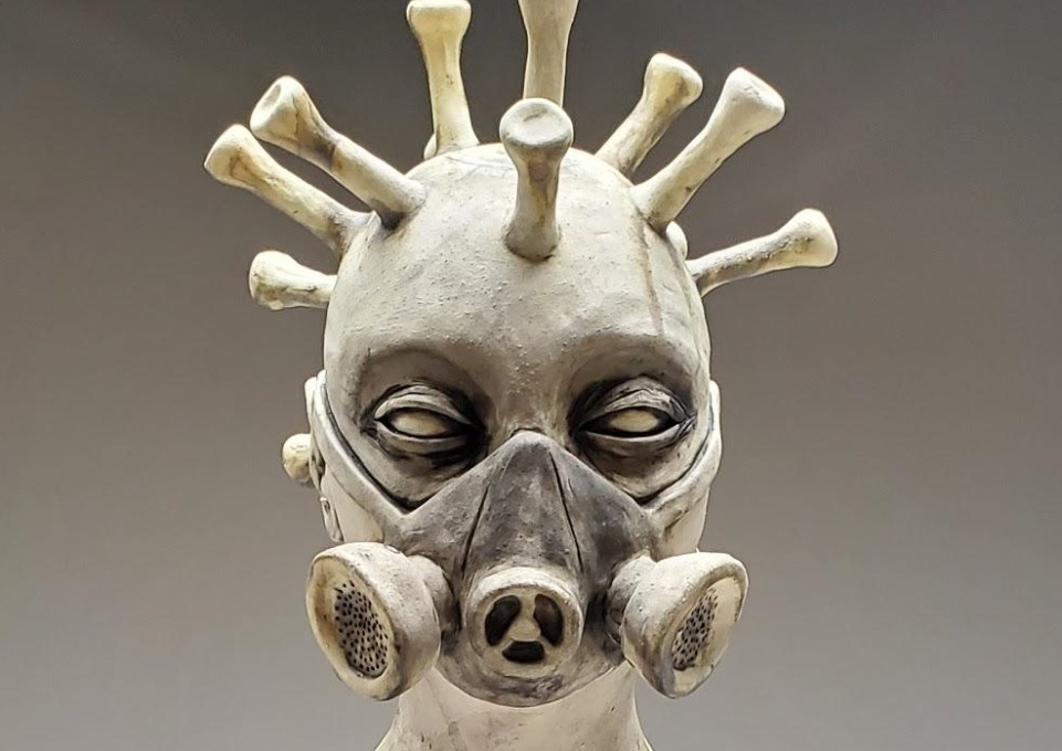 Clay scupture of head in gas mask
