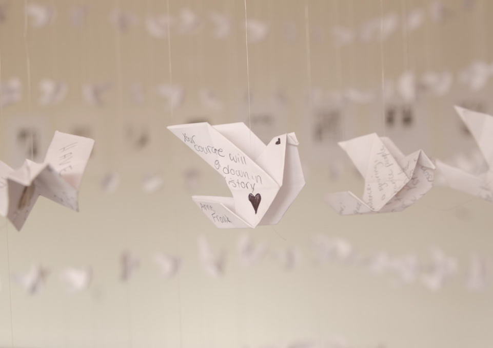 Origami bird with inscription "Your courage will go down in history."