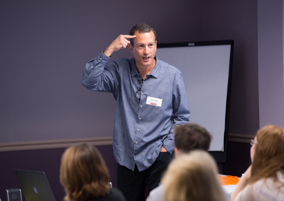 Drew Kahn speaking to a group