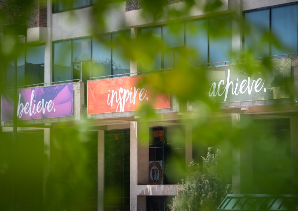 Exterior front of the Campbell Student Union with the Believe, Inspire, Achieve banners displayed
