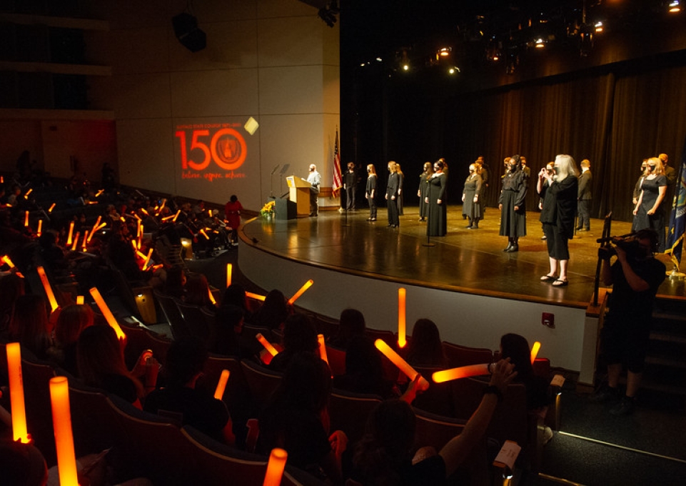 Wide angle shot of the chamber choir on stage as viewed from the audience