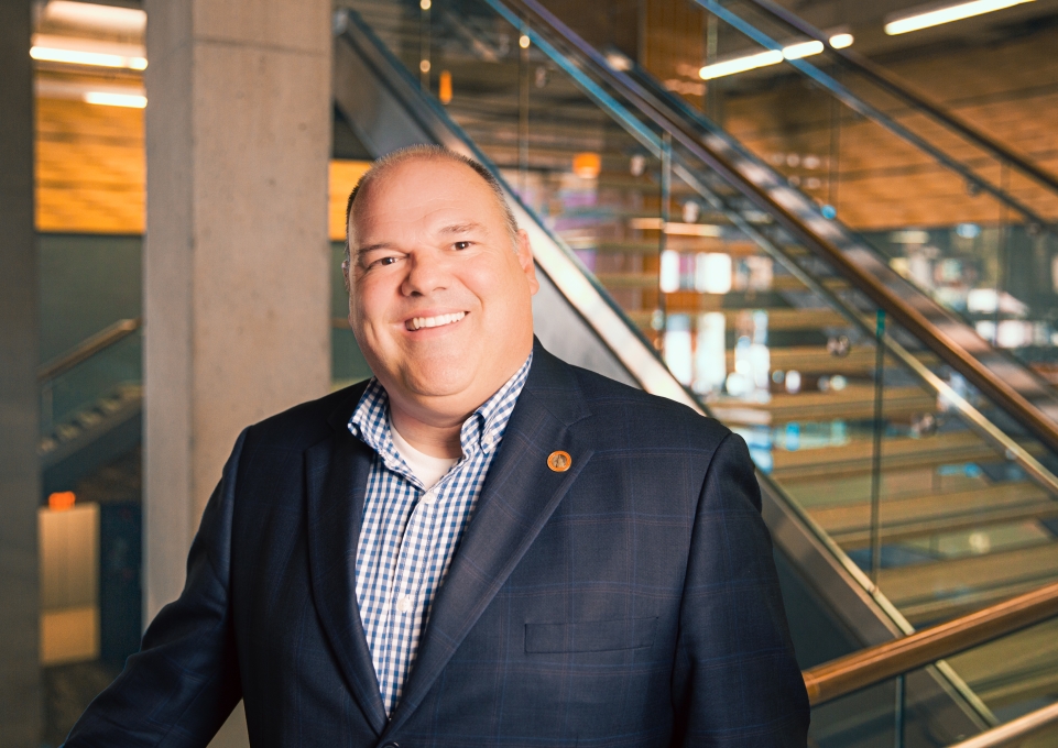 Randy Bowen posing in front of staircase in Student Union