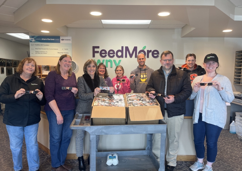 group of people with eclipse glasses