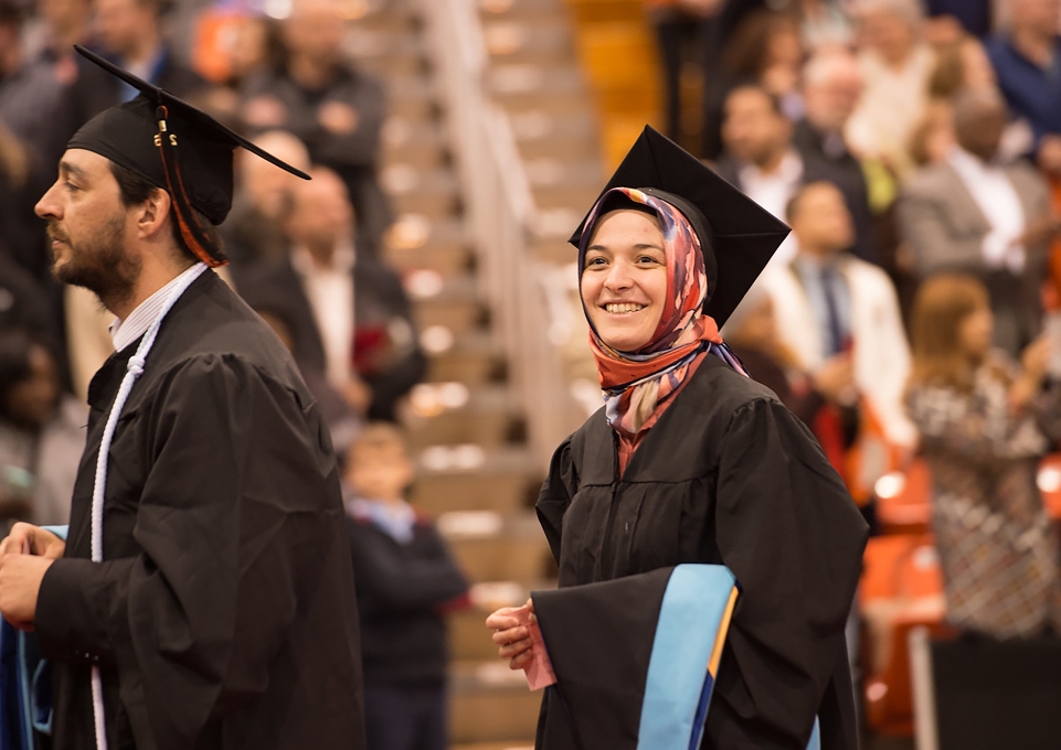 Smiling students processing into the Commencement ceremony