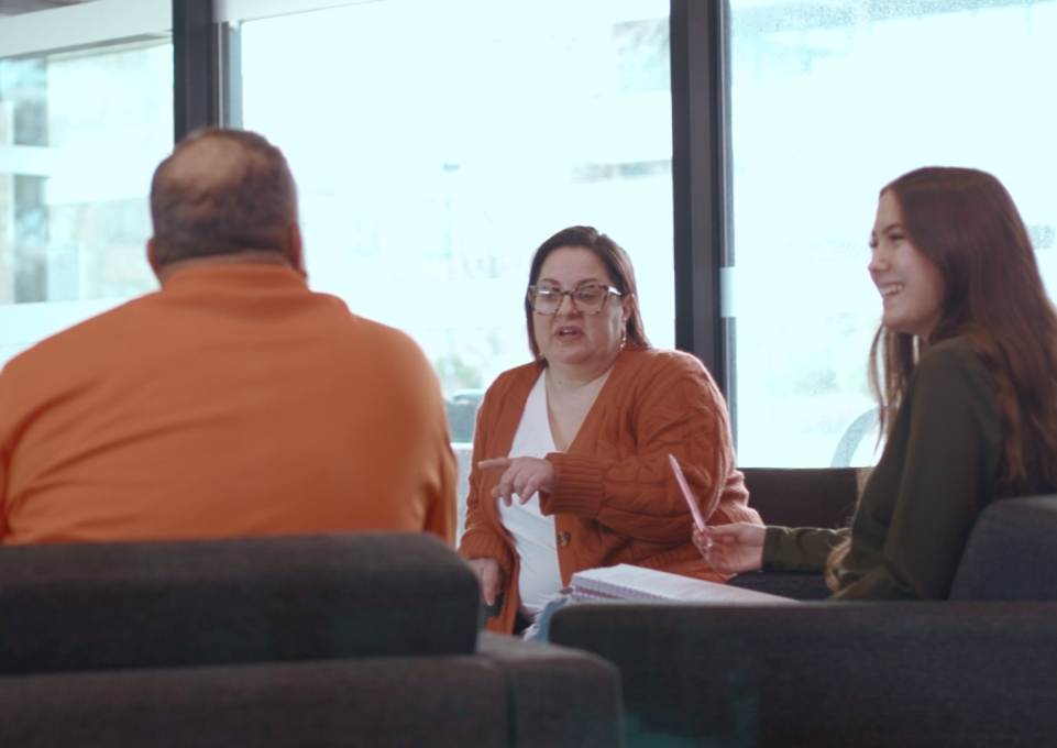 Female professor talking to two students